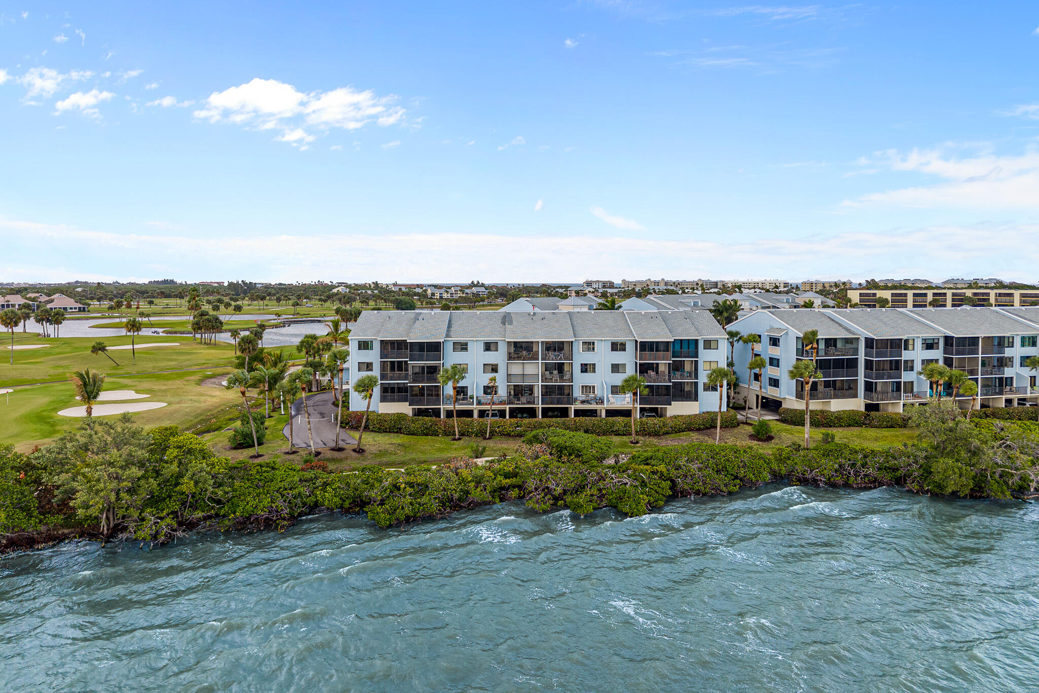 10 Northeast Plantation Road, Unit 305 Jensen Beach, FL 34957 - Photo 5 of 48 a view of a lake with a building in front of it