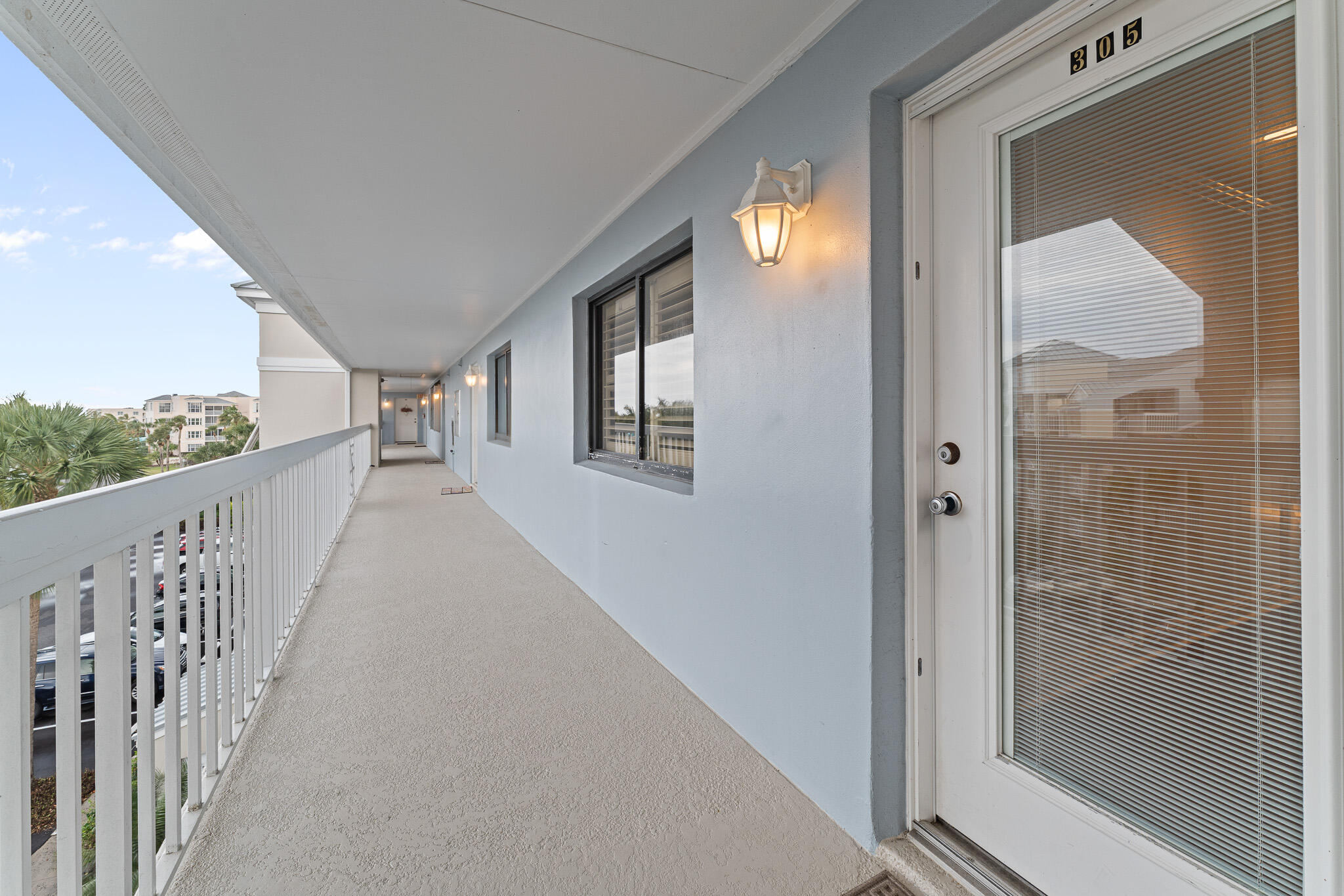 10 Northeast Plantation Road, Unit 305 Jensen Beach, FL 34957 - Photo 8 of 48 a view of a hallway with wooden floor and windows