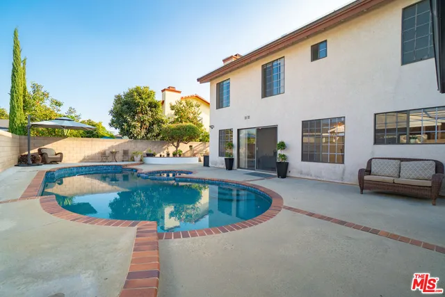 a view of a street with potted plants