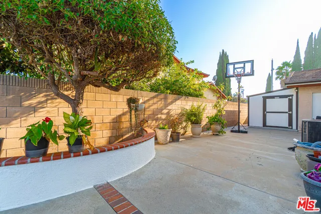a view of a house with a swimming pool and a yard