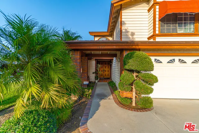 a vase of flowers sitting on a floor