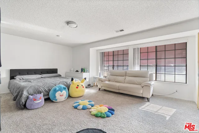 a bedroom with a bed and a tv