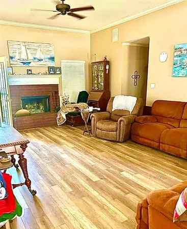 a living room with furniture a floor to ceiling window and a flat screen tv