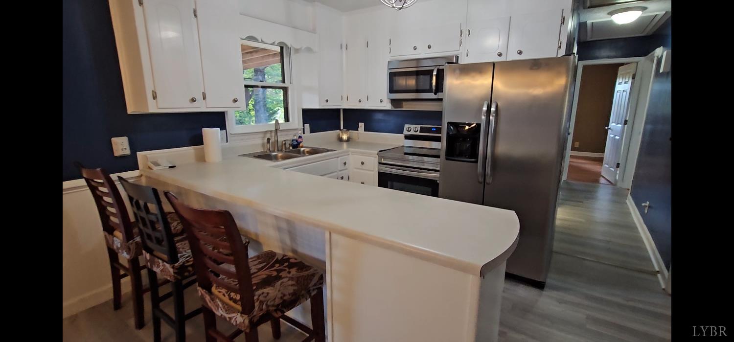 102 Ridgeview Road Hurt, VA 24563 - Photo 11 of 41 a kitchen with stainless steel appliances a refrigerator stove microwave and sink