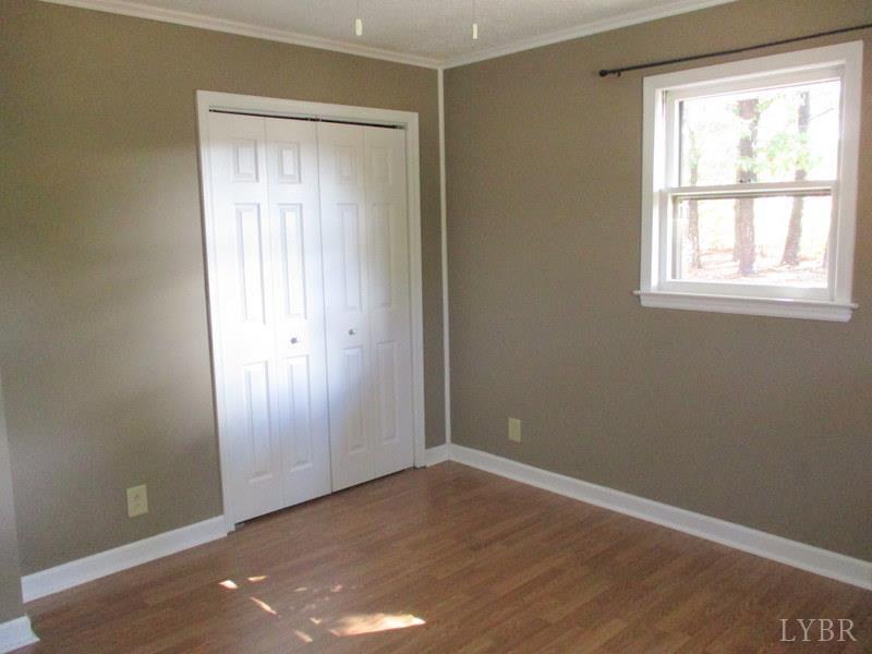102 Ridgeview Road Hurt, VA 24563 - Photo 21 of 41 an empty room with wooden floor and windows