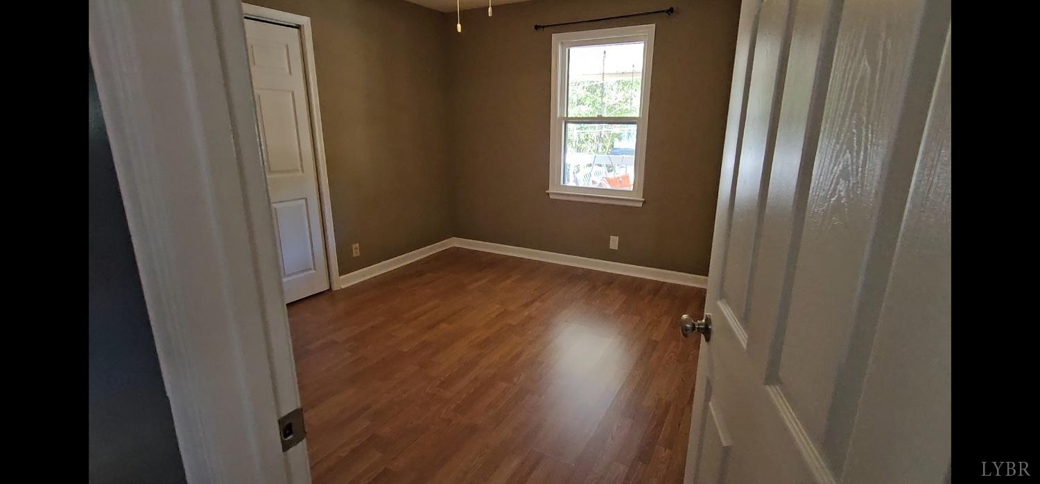 102 Ridgeview Road Hurt, VA 24563 - Photo 24 of 41 a view of an empty room with wooden floor and a window