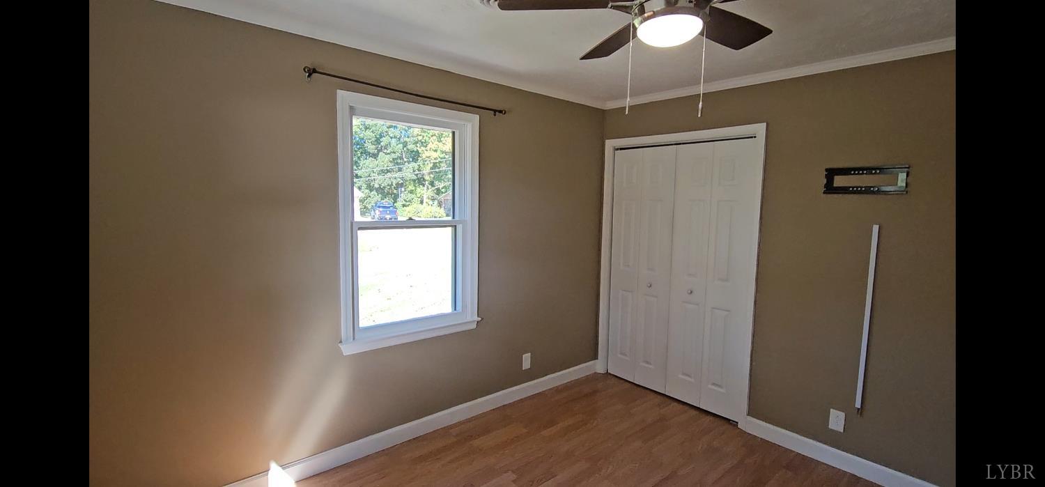 102 Ridgeview Road Hurt, VA 24563 - Photo 26 of 41 a view of an empty room with wooden floor and a window