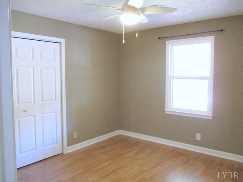 102 Ridgeview Road Hurt, VA 24563 - Photo 28 of 41 an empty room with a window and wooden floor