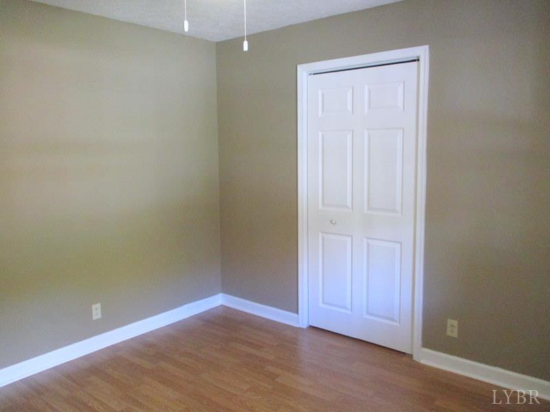 102 Ridgeview Road Hurt, VA 24563 - Photo 30 of 41 an empty room with wooden floor and closet area