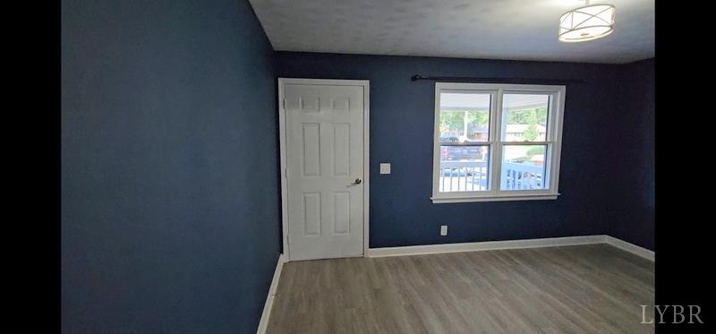 102 Ridgeview Road Hurt, VA 24563 - Photo 8 of 41 an empty room with wooden floor and windows