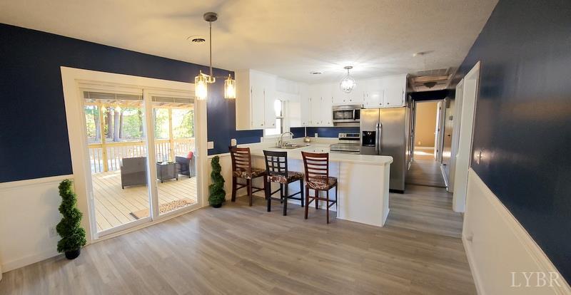 102 Ridgeview Road Hurt, VA 24563 - Photo 10 of 41 a kitchen with stainless steel appliances a dining table chairs stove and refrigerator