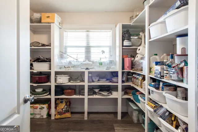 a bedroom with a bed a couch and large window