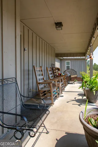 a view of a lake with big yard and large trees