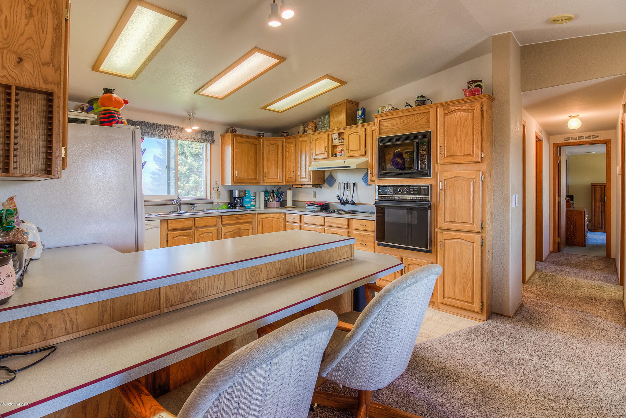 181 Prairie Road Moxee, WA 98936 - Photo 22 of 66 a room with stainless steel appliances kitchen island granite countertop furniture and a refrigerator