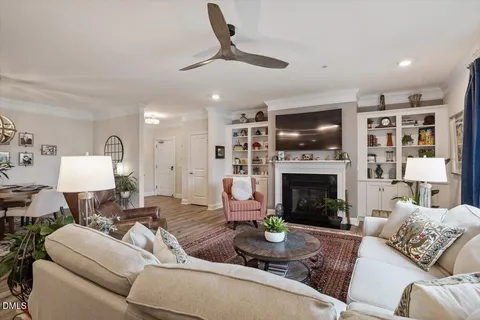 a living room with furniture and a chandelier