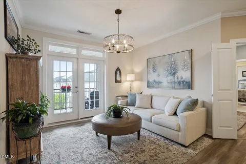 a living room with furniture and a chandelier