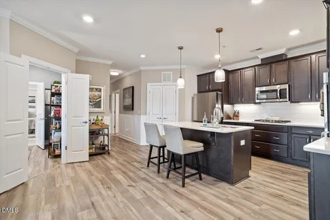 a large kitchen with a counter space dining table and chairs