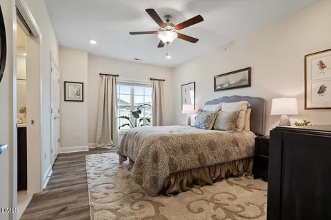 a living room with a bed furniture and a flat tv screen