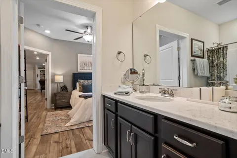 a bedroom with a large bed and a ceiling fan