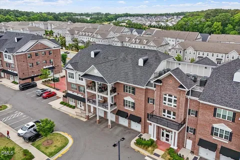 an aerial view of residential houses with outdoor space and street view