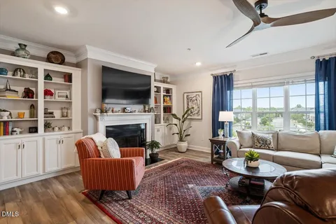 a living room with furniture fireplace and flat screen tv