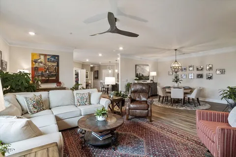 a view of a dining room with furniture wooden floor and a chandelier