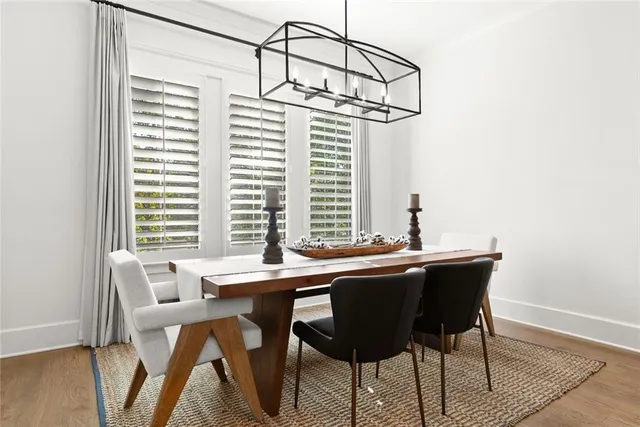 a living room with patio furniture and a floor to ceiling window
