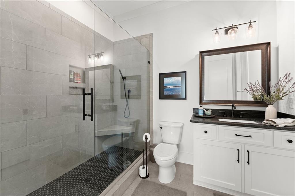 3116 Winding Lake Court Gainesville, GA 30504 - Photo 35 of 94 a bathroom with a granite countertop sink toilet and shower