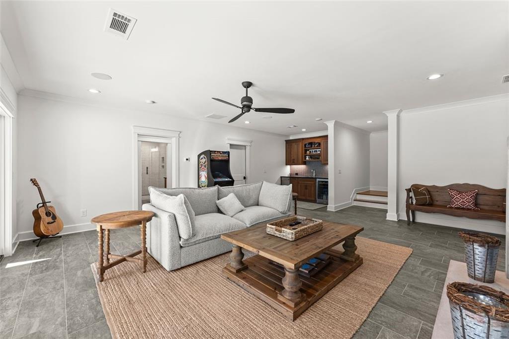 3116 Winding Lake Court Gainesville, GA 30504 - Photo 45 of 94 a living room with furniture a rug and a chandelier