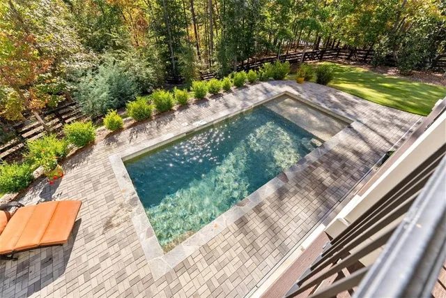 a view of a yard with plants and trees
