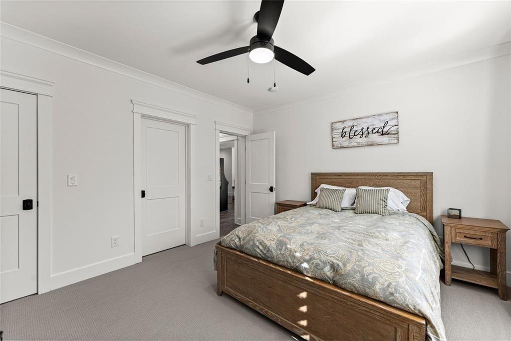 3116 Winding Lake Court Gainesville, GA 30504 - Photo 54 of 94 a bedroom with a bed and a chandelier