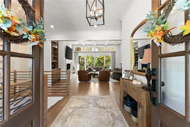 a kitchen with a dining table chairs stainless steel appliances and cabinets