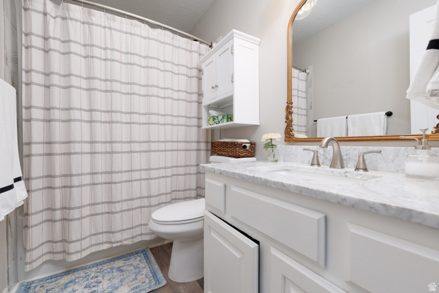 260 400 North, Unit 1 Orem, UT 84057 - Photo 13 of 17 Bathroom featuring vanity, a textured ceiling, and light wood-style flooring