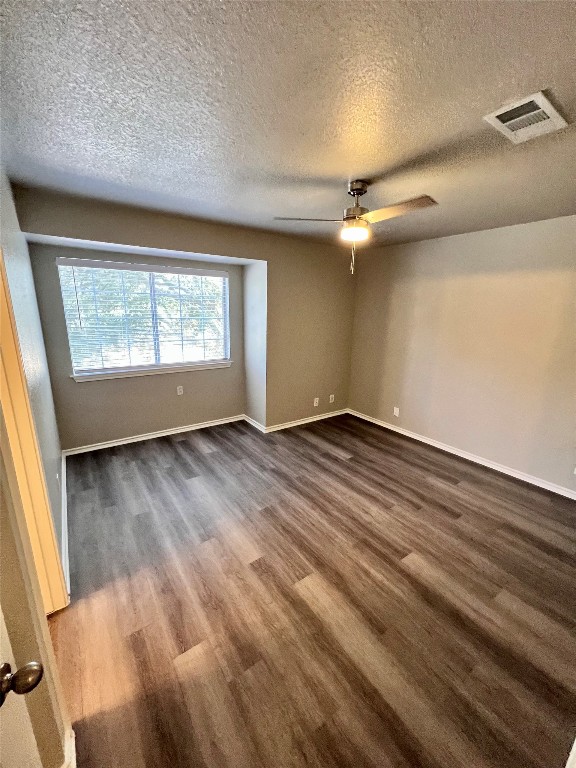 1801 Constantino Circle, Unit A Austin, TX 78745 - Photo 14 of 23 an empty room with wooden floor fan and windows