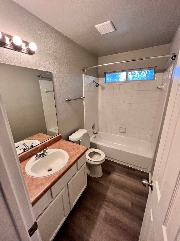 1801 Constantino Circle, Unit A Austin, TX 78745 - Photo 20 of 23 a bathroom with a granite countertop bathtub sink vanity mirror and toilet