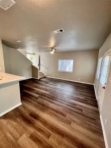 a view of entryway and hall with wooden floor
