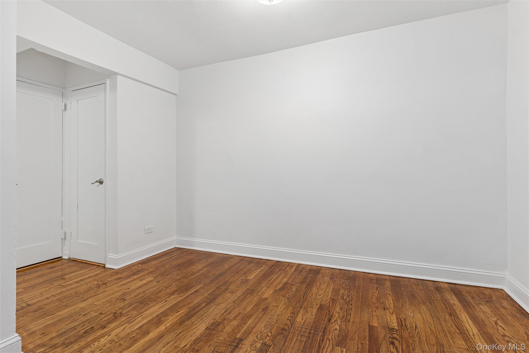 67-12 Yellowstone Boulevard, Unit B16 Queens, NY 11375 - Photo 6 of 15 Unfurnished bedroom featuring wood finished floors and baseboards