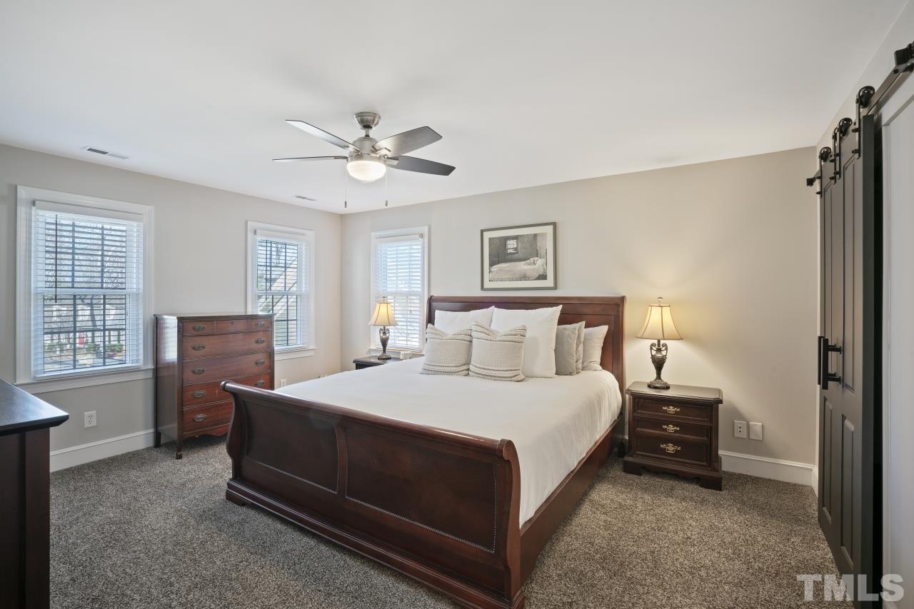 2209 Middlefield Court Raleigh, NC 27615 - Photo 12 of 25 a bedroom with a bed and a table in it with window