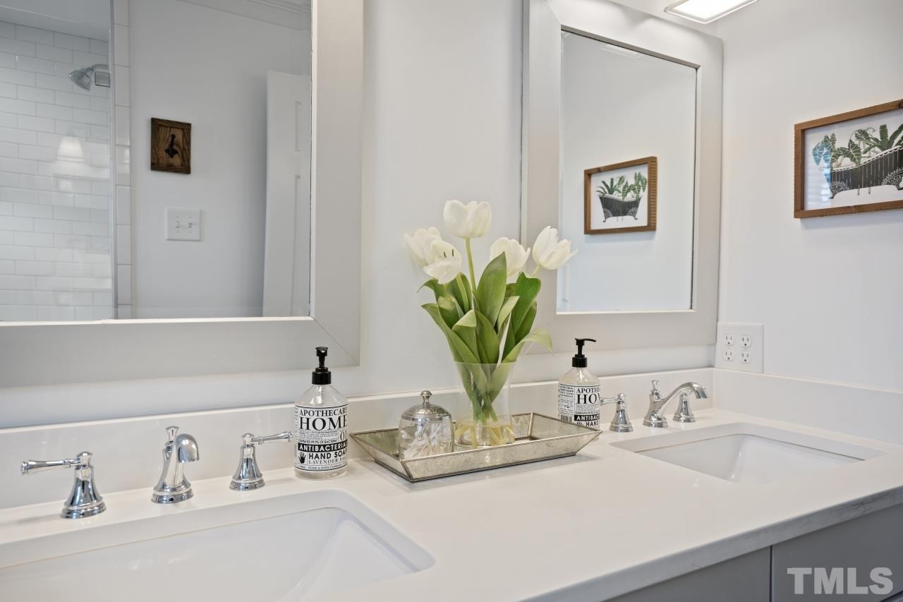 2209 Middlefield Court Raleigh, NC 27615 - Photo 15 of 25 a bathroom with a sink and a mirror