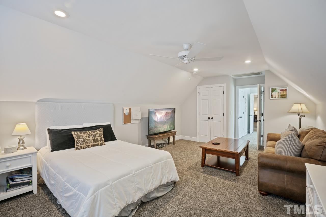 2209 Middlefield Court Raleigh, NC 27615 - Photo 17 of 25 a bedroom with furniture and a lamp