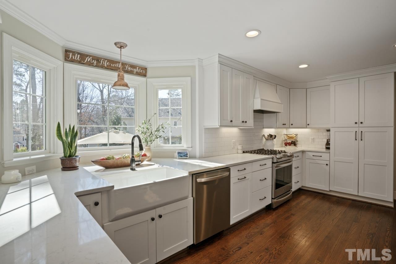 2209 Middlefield Court Raleigh, NC 27615 - Photo 2 of 25 a kitchen that has a sink and a stove in it