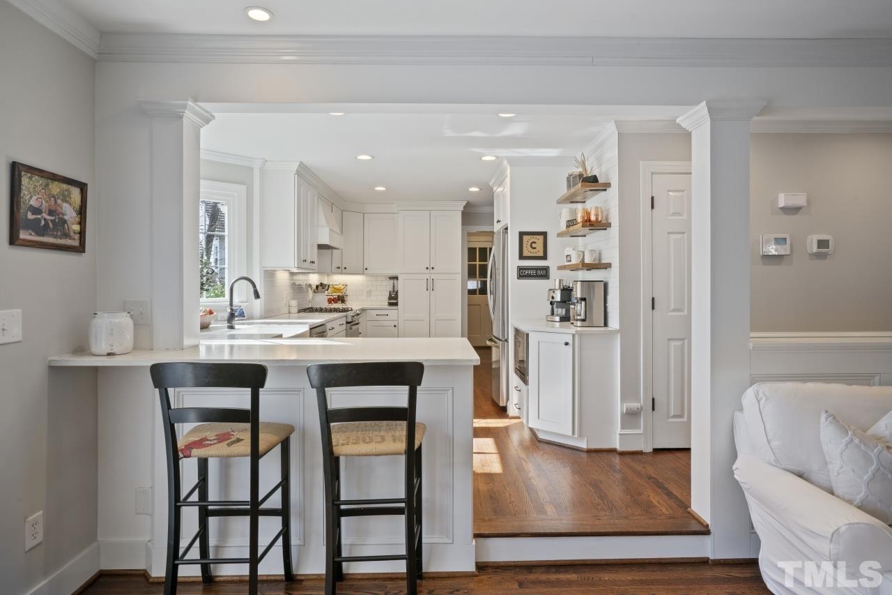2209 Middlefield Court Raleigh, NC 27615 - Photo 3 of 25 a kitchen with a dining table chairs refrigerator and cabinets