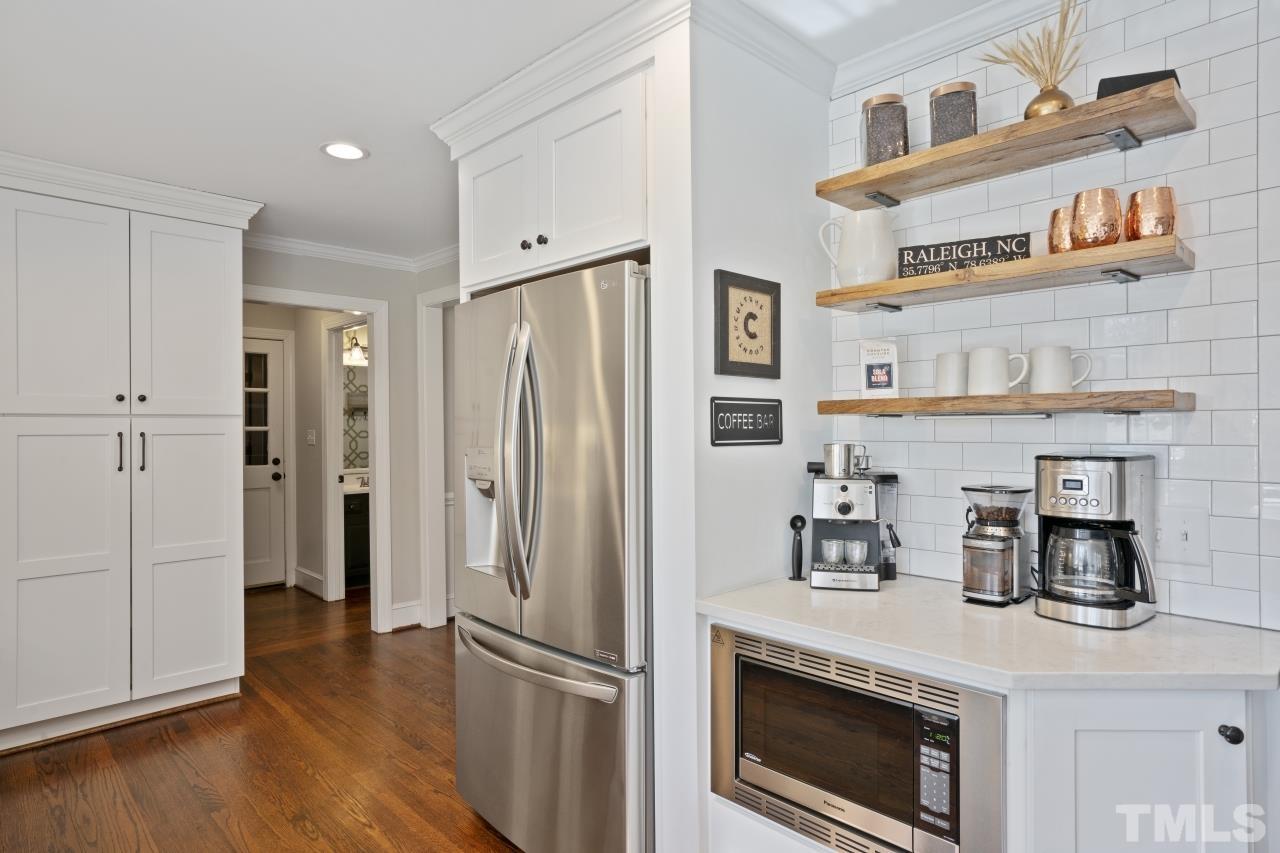 2209 Middlefield Court Raleigh, NC 27615 - Photo 5 of 25 a kitchen with stainless steel appliances a refrigerator and a stove top oven