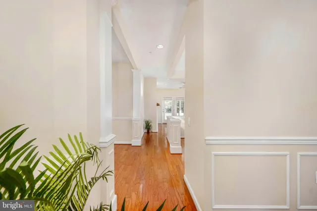 a view of a house with a yard and potted plants large tree