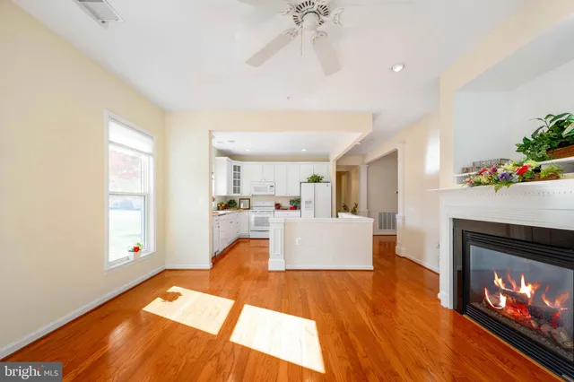a living room with furniture a fireplace and a chandelier