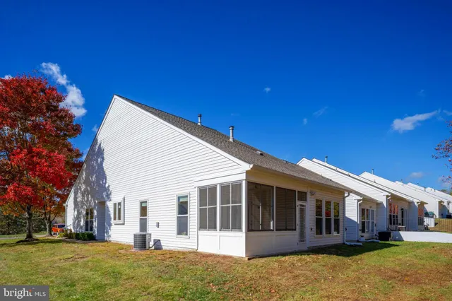 a large dining hall with stainless steel appliances granite countertop a stove and a dining table