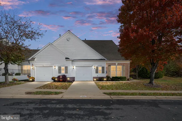 a view of a tennis ground with large trees