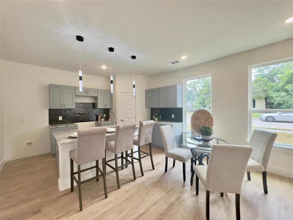 3801 Carpenter Avenue Dallas, TX 75210 - Photo 6 of 19 a view of a dining room with furniture and wooden floor