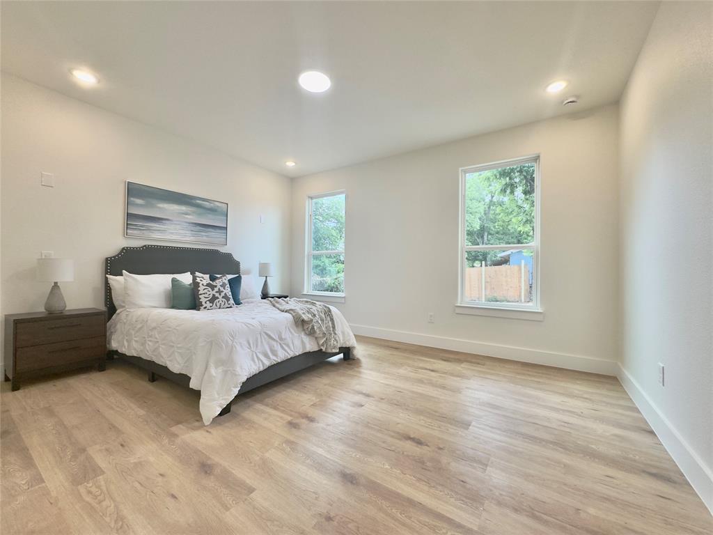 3801 Carpenter Avenue Dallas, TX 75210 - Photo 8 of 19 a bedroom with a bed and a large window