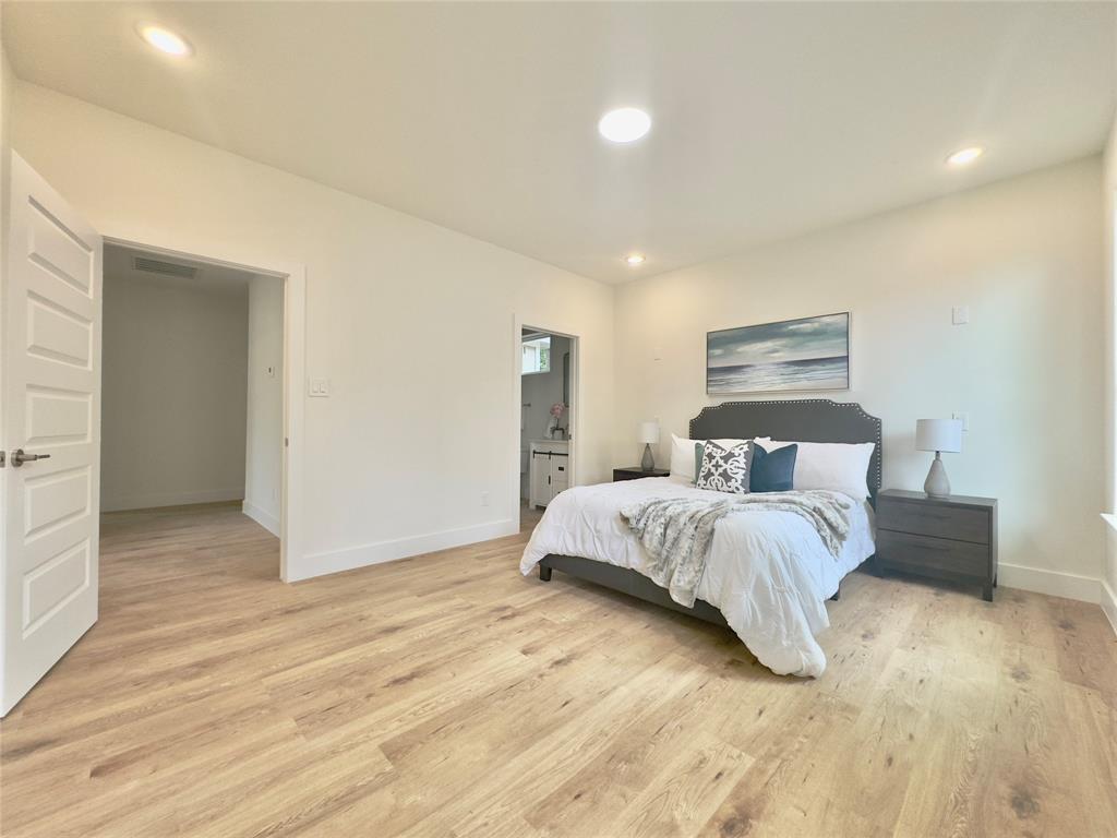 3801 Carpenter Avenue Dallas, TX 75210 - Photo 9 of 19 a bedroom with a bed and a night stand